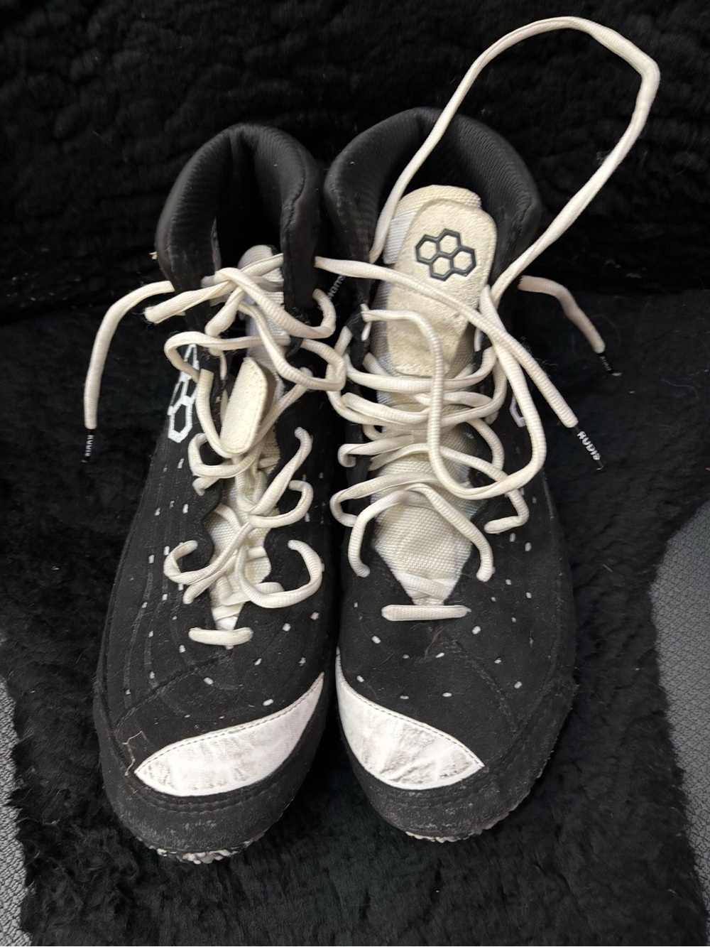 Rudis.   Black sneakers.  Wrestling shoes.
